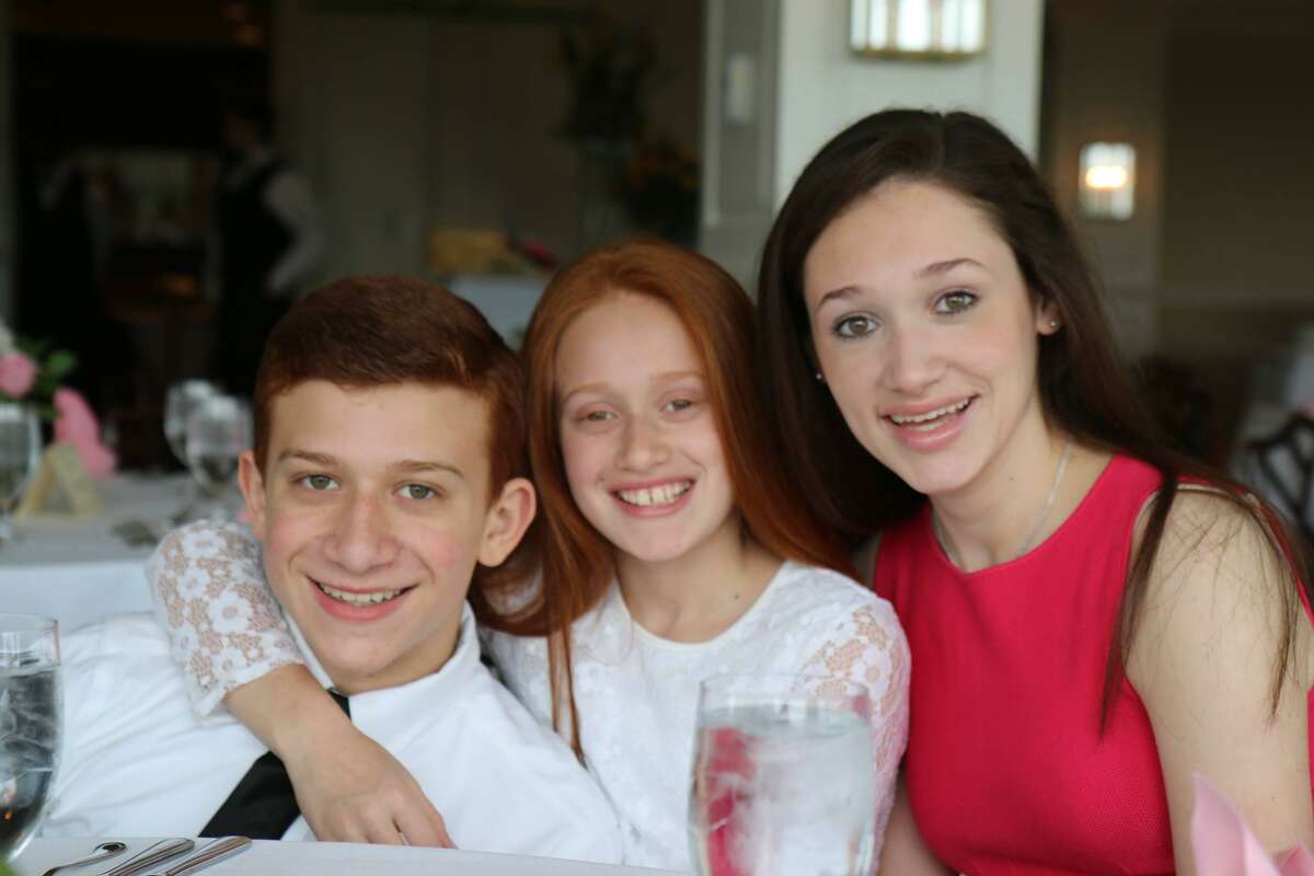 Staples High School Valedictorian Emily Schussheim (right) with her brother Benjamin Schussheim and sister Rebecca Schussheim