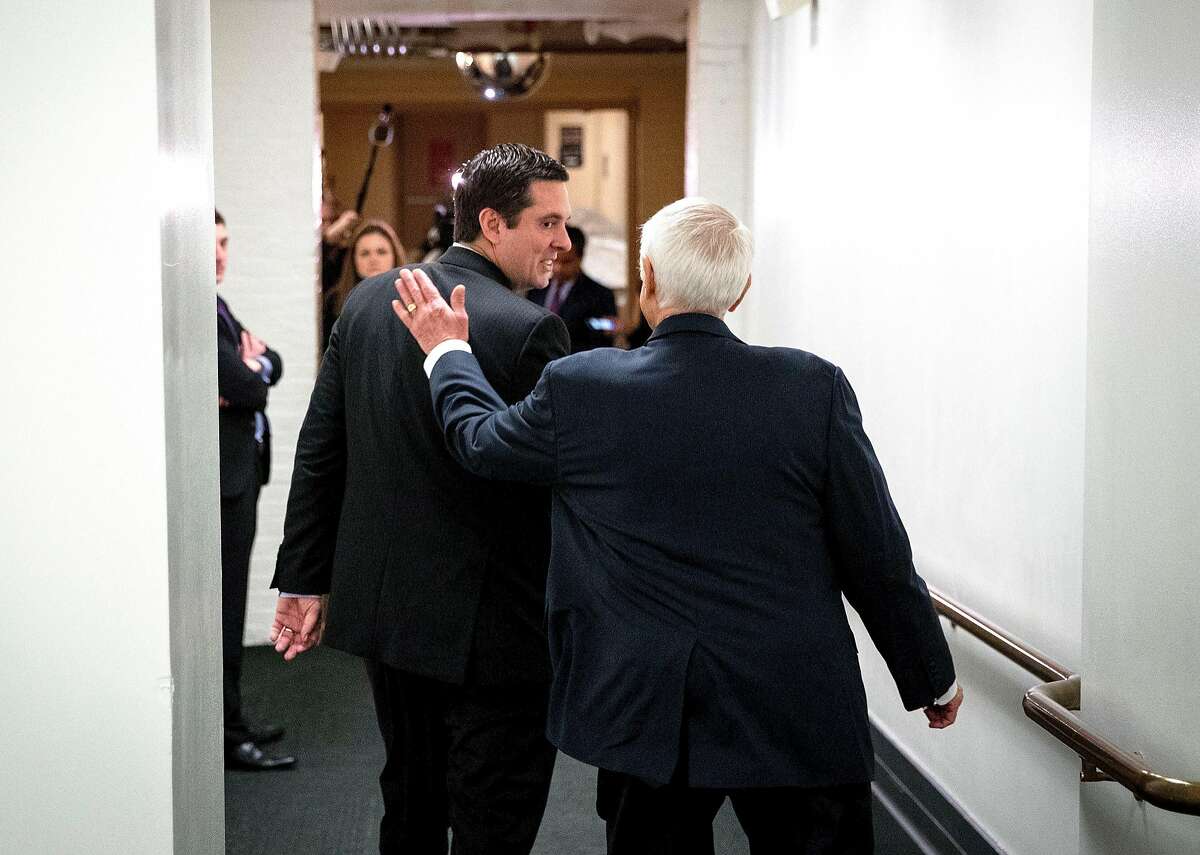 Rep. Devin Nunes (R-Calif.), chairman of the House Intelligence Committee, gets a pat on the back from Rep. John Carter (R-Texas) following a House Republican conference meeting on Capitol Hill in Washington, March 28, 2017. Top House Democrats called on Nunes to recuse himself from the panel�s investigation into Russian meddling in the 2016 presidential election, thrusting the entire inquiry into jeopardy amid what they described as mounting evidence he was too close to President Trump to be impartial. (Doug Mills/The New York Times)