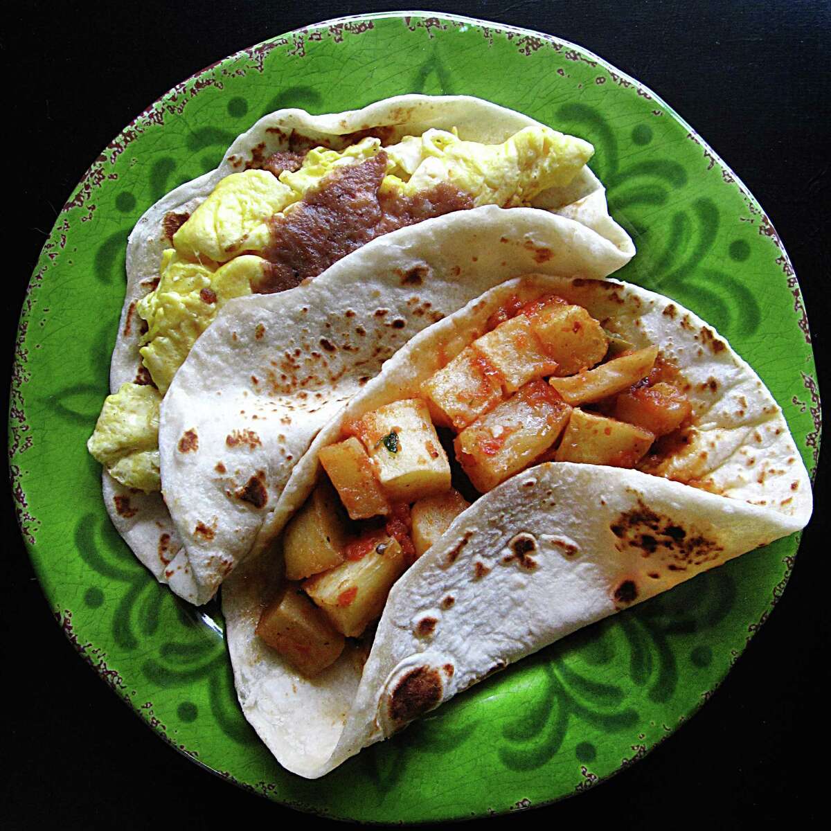 Bean and egg breakfast taco and a papas rancheras breakfast taco, both on handmade flour tortillas, from 4 Missions Cafe on Southton Road.