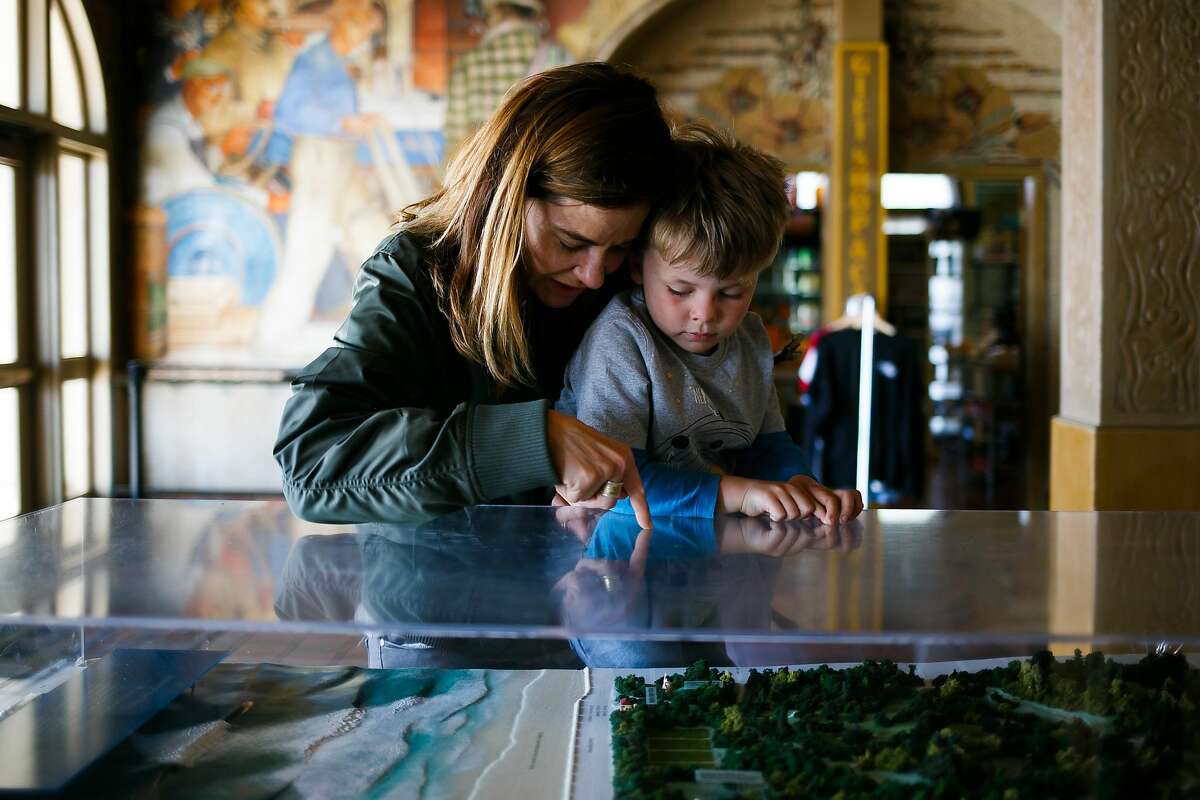 Kristen Sager holds up her five-year-old son Magnus Nyberg, to look at the scale model of Golden Gate Park at Beach Chalet in San Francisco, Calif. Friday, March 31, 2017.