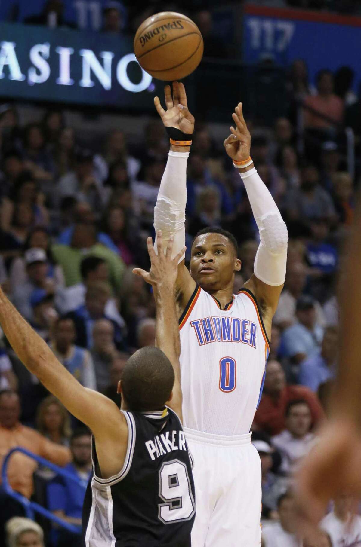 Oklahoma City Thunder guard Russell Westbrook (0) shoots over San Antonio Spurs guard Tony Parker (9) in the second quarter of an NBA basketball game in Oklahoma City, Friday, March 31, 2017. (AP Photo/Sue Ogrocki)