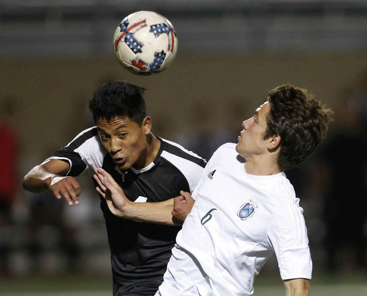 Clark's Angel Caballero (left) and Reagan's Jacob Galan (06) compete for the ball in 6A second-round boys soccer at Farris Stadium on Friday, Mar. 31, 2017. (Kin Man Hui/San Antonio Express-News)