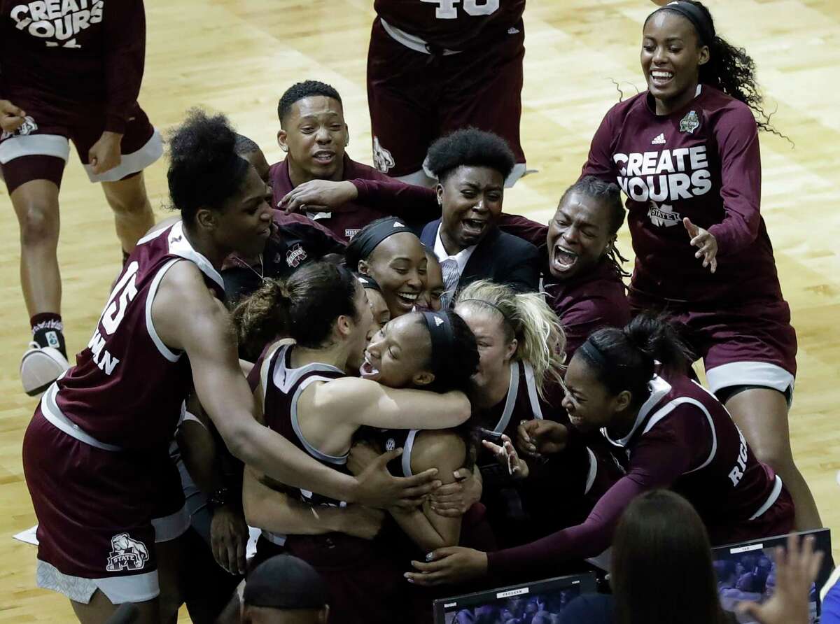Mississippi State guard Morgan William, center, celebrates with teammates after she hit the winning shot at the buzzer in overtime to defeat Connecticut in an NCAA college basketball game in the semifinals of the women's Final Four, Friday, March 31, 2017, in Dallas. Mississippi State won 66-64. (AP Photo/Eric Gay)