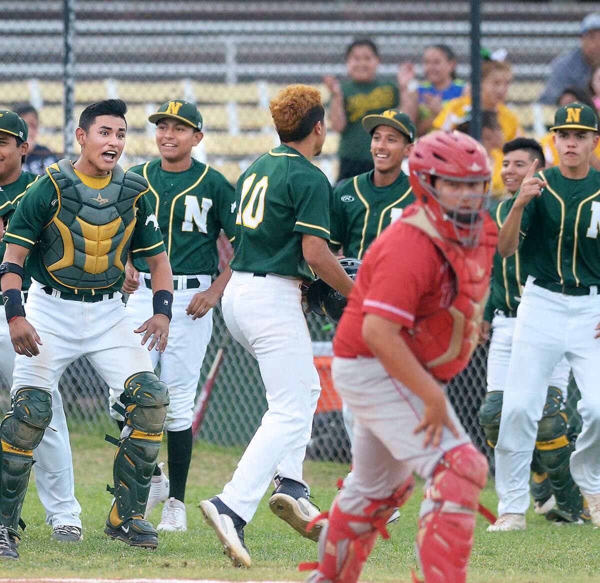 Nixon teammates celebrate in the third inning and the Mustangs had plenty to celebrate about as they throttled rival Martin 14-3 on Friday evening at Veterans Field.