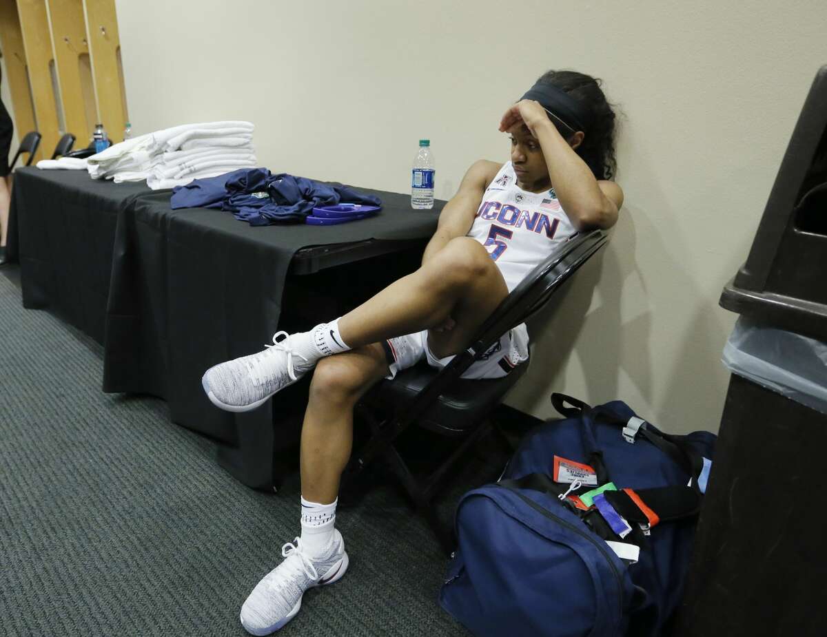 Connecticut guard Crystal Dangerfield (5) sits in the locker room after the team's loss to Mississippi State in an NCAA college basketball game in the semifinals of the women's Final Four, Saturday, April 1, 2017, in Dallas. Mississippi State won 66-64. (AP Photo/Tony Gutierrez)