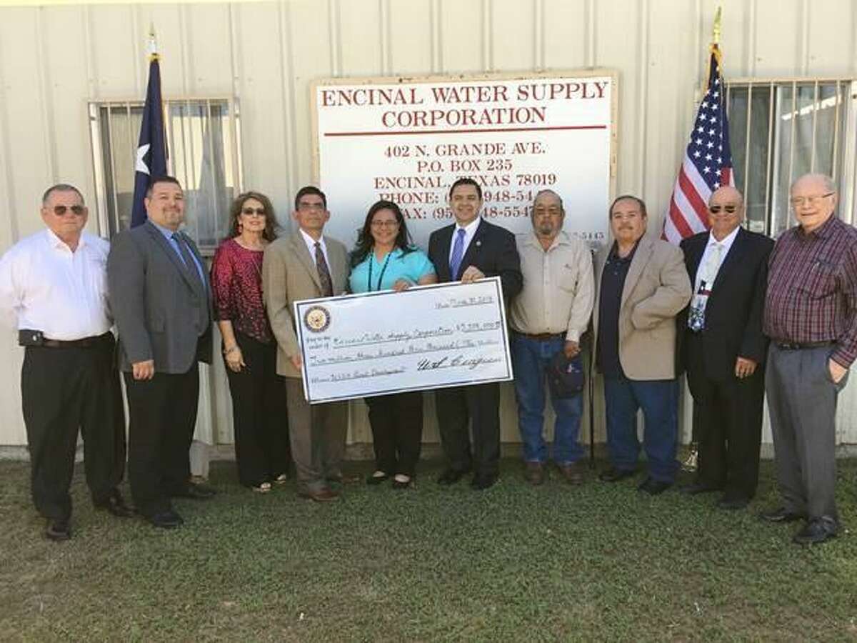 Congressman Henry Cuellar presents a check for $2,303,000 from the U.S. Department of Agriculture Office of Rural Development to the Encinal Water Supply Corporation on Friday. The federal funds will be used for water infrastructure projects in Encinal.