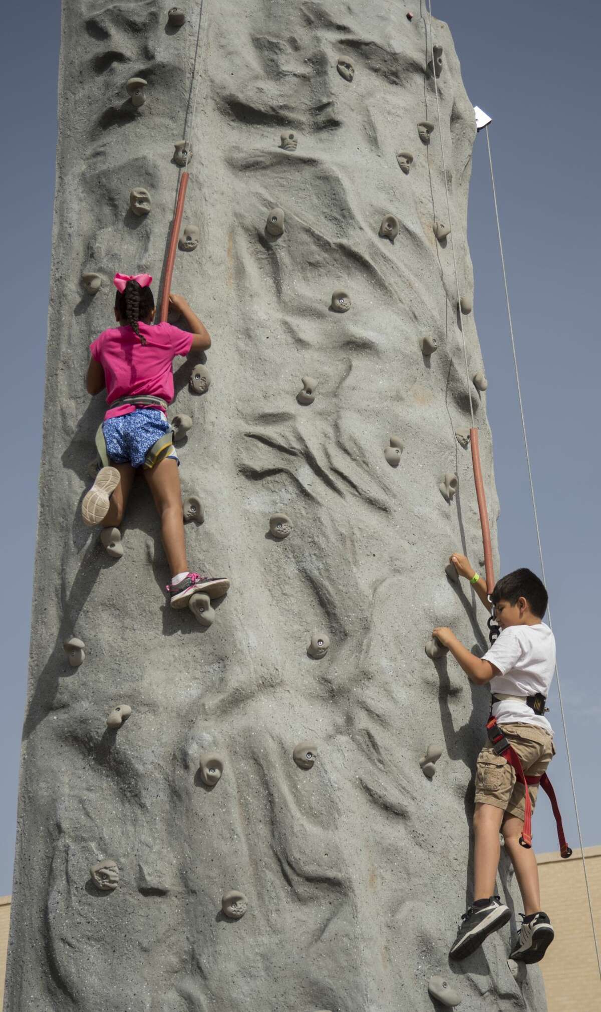 Participants try their luck on a climbing wall 04-01-17 at the Midland YMCA Egg-Stravaganza. Tim Fischer/Reporter-Telegram