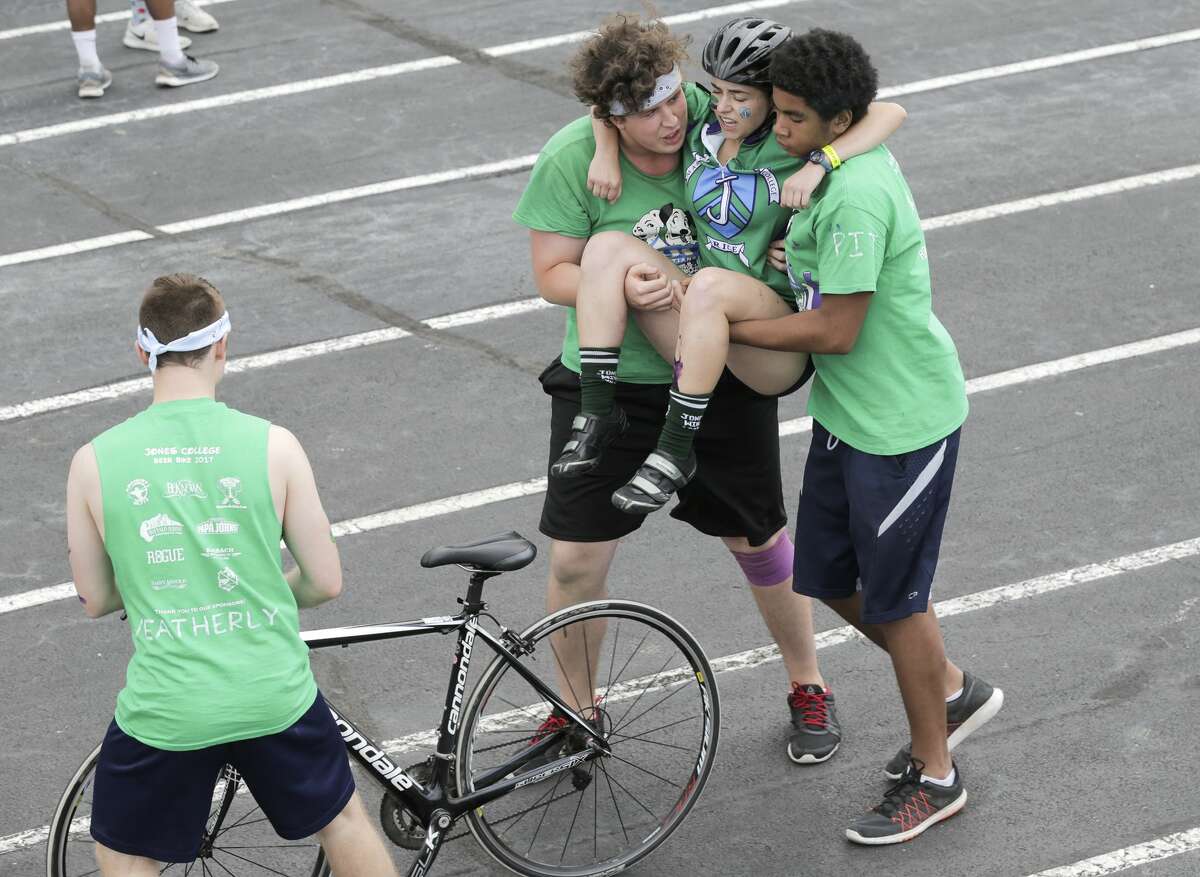 Jones College cyclist is taken off her bicycle after competing in Rice University's 60th Annual Beer Bike competition on Saturday, April 1, 2017, in Houston. ( Elizabeth Conley / Houston Chronicle )