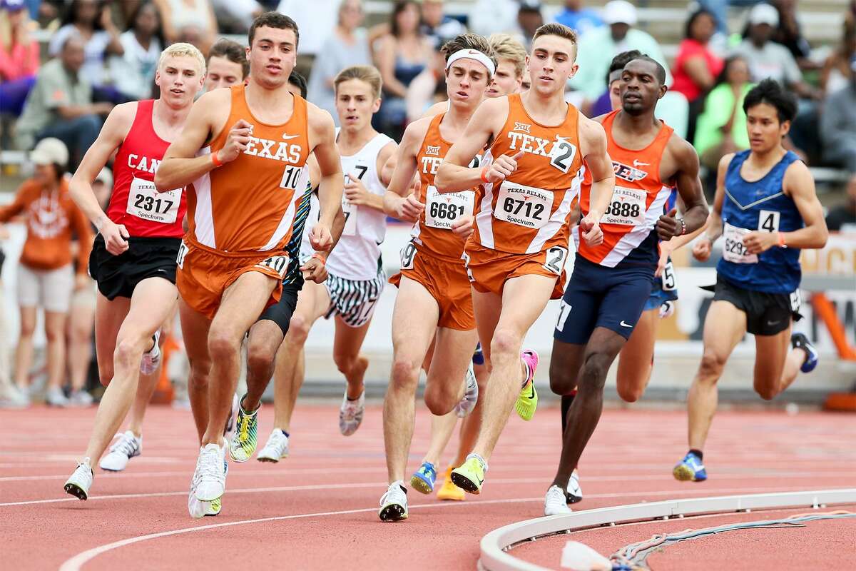 New Braunfels Canyon's Sam Worley (left) runs outside the pack led by UT's Alex Rogers (2), a former teammate, on the first turn of the Jerry Thompson Invitational Mile Run during the 2017 Texas Relays at Mike A. Myers Stadium in Austin on Saturday, April 1, 2017. MARVIN PFEIFFER/ mpfeiffer@express-news.net