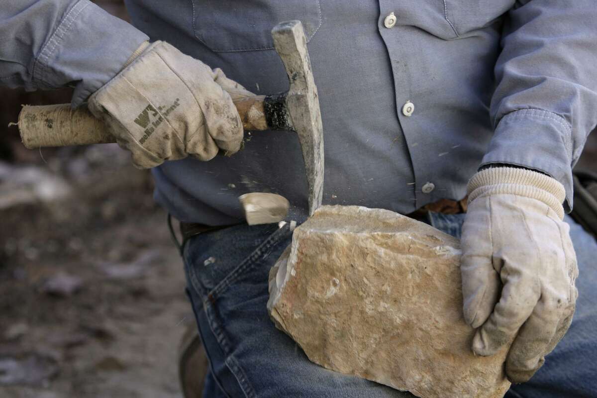 Blas Perez breaks rock as he repairs a limestone border near building 23 at La Villita in 2010. Hand-hewn limestone blocks formed much of San Antonio’s early buildings, including the Spanish colonial missions and San Fernando Cathedral.
