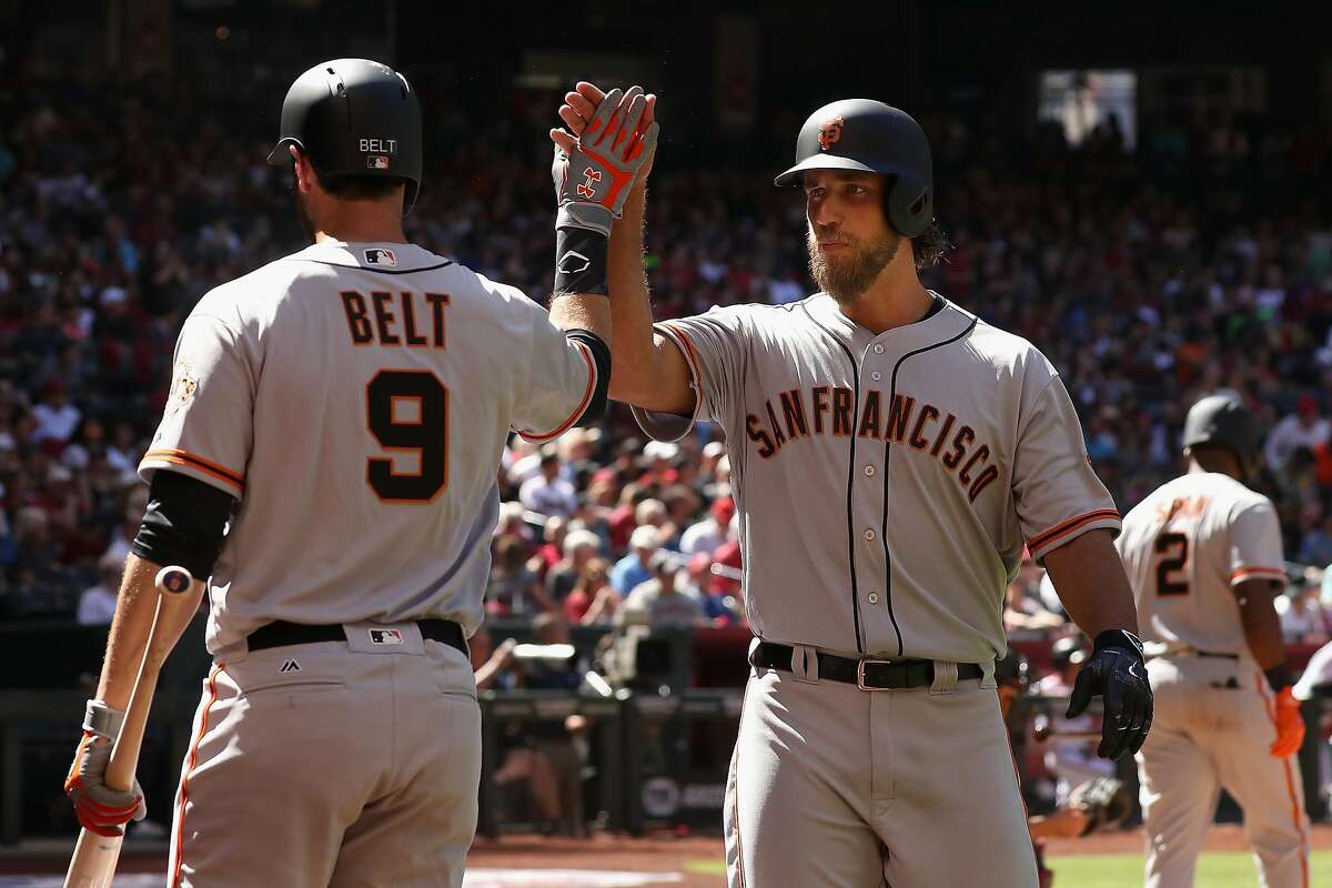 PHOENIX, AZ - APRIL 02: Madison Bumgarner #40 of the San Francisco Giants high fives Brandon Belt #9 after Bumgarner hit a solo home run against the Arizona Diamondbacks during the fifth inning of the MLB opening day game at Chase Field on April 2, 2017 in Phoenix, Arizona. (Photo by Christian Petersen/Getty Images)