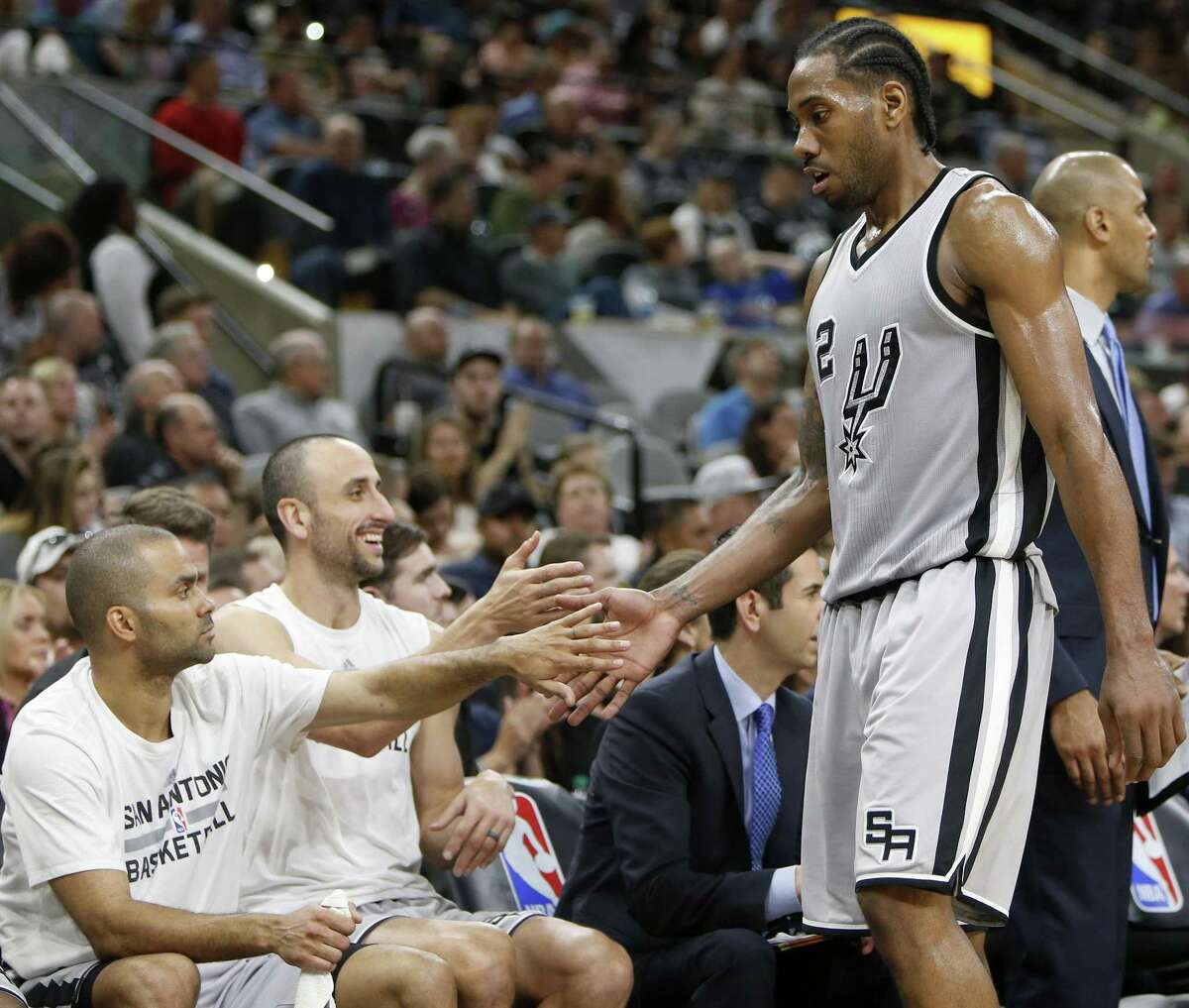 San Antonio Spurs' Tony Parker (from left), and Manu Ginobili greet Kawhi Leonard as he walks to the bench during second half action against the Utah Jazz Sunday April 2, 2017 at the AT&T Center. The Spurs won 109-103.