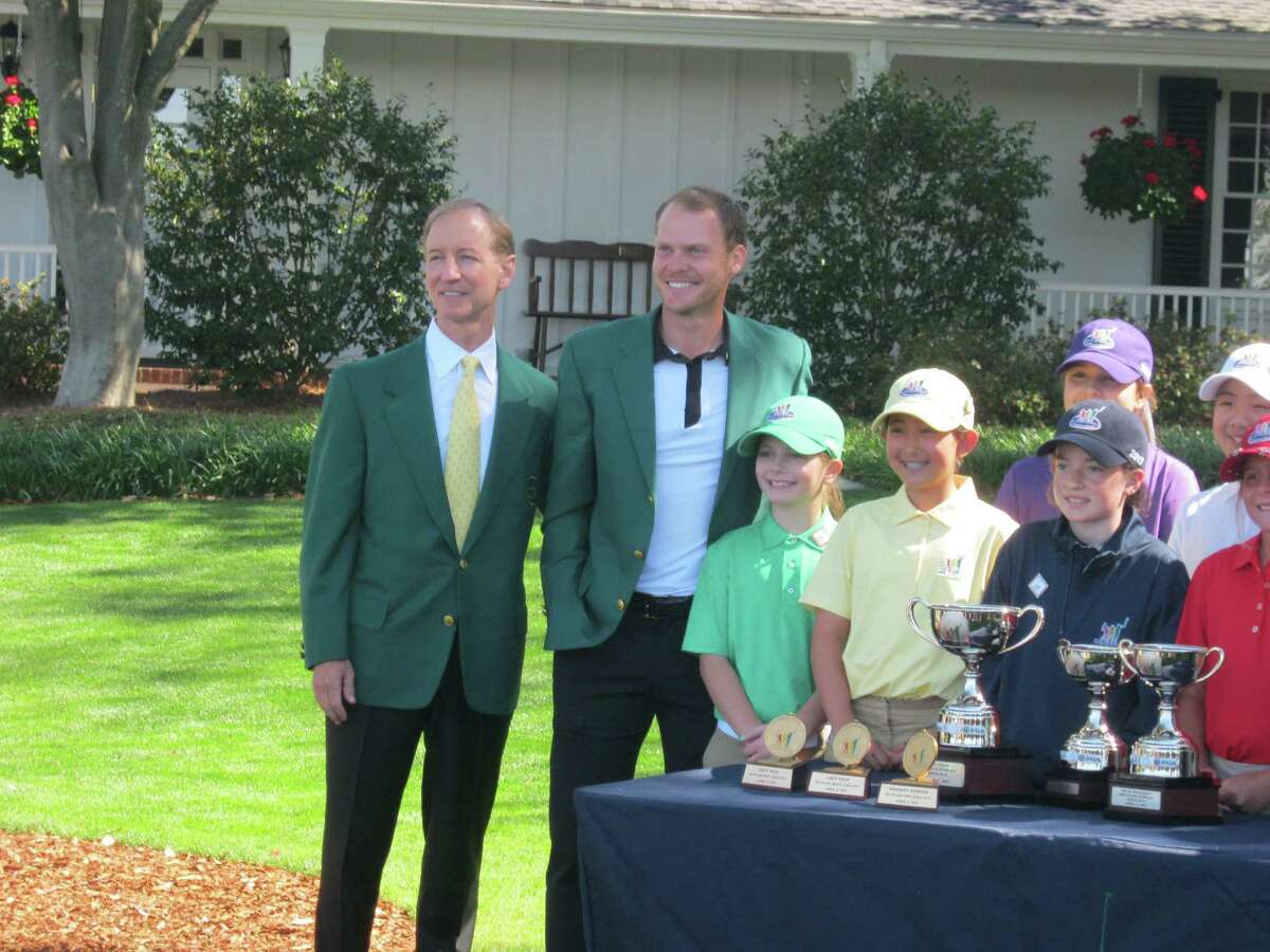 Participants in the girls' 10-11 age division of the national Drive, Chip and Putt Championship pose with an Augusta National member, far left, and 2016 Masters champion Danny Willett outside the Augusta National Golf Club clubhouse in Augusta, Ga. That's Kennedy Swedick, a 10-year-old from Voorheesville, in the green shirt with Willett. (Pete Dougherty / Times Union)
