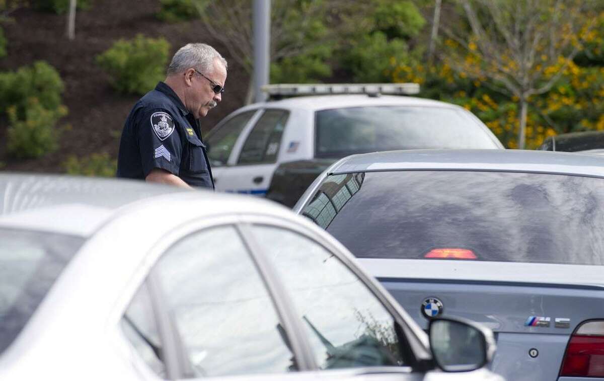 FILE — Stamford Police Department officers pull over and ticket drivers caught texting or talking on cell phones while driving at the intersection of Elm St. and North State Street in Stamford, Conn., on Wednesday, September 3, 2014.