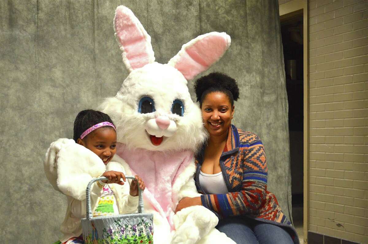 Shandia Mitchell of New Canaan and her daughter, Amira-Marie, 7, pose with the Easter Bunny at the Young Women's League's 45th annual Easter Egg Hunt at the New Canaan High School, Saturday, Apr. 1, 2017, in New Canaan, Conn.