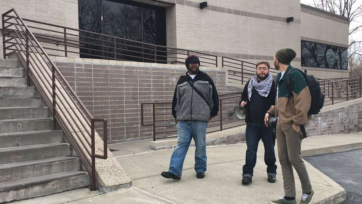 Dominic Ricardo Morgan of Utica, at left, arrives at the federal Immigration and Customs Enforcement office in Colonie Monday. A Jamaican immigrant is scheduled to meet with ICE agents for his monthly check-in soon after. (Emily Masters / Times Union)