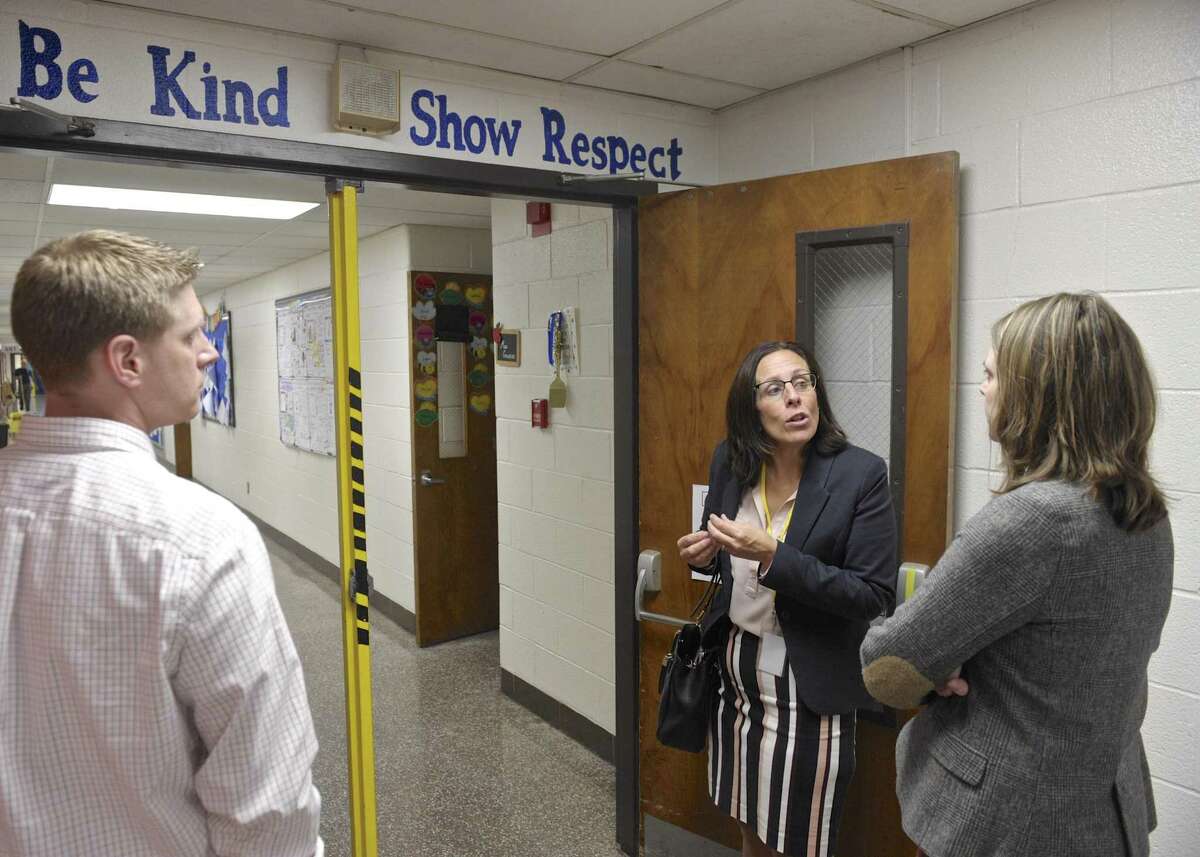 Kristan and Jim Sveda, of Bethel, listen to Bethel Superintendent of Schools Christine Carver during a tour of Rockwell School. Wednesday, October 5, 2016, in Bethel, Conn. The Sveda's have a son in second grade in the school.