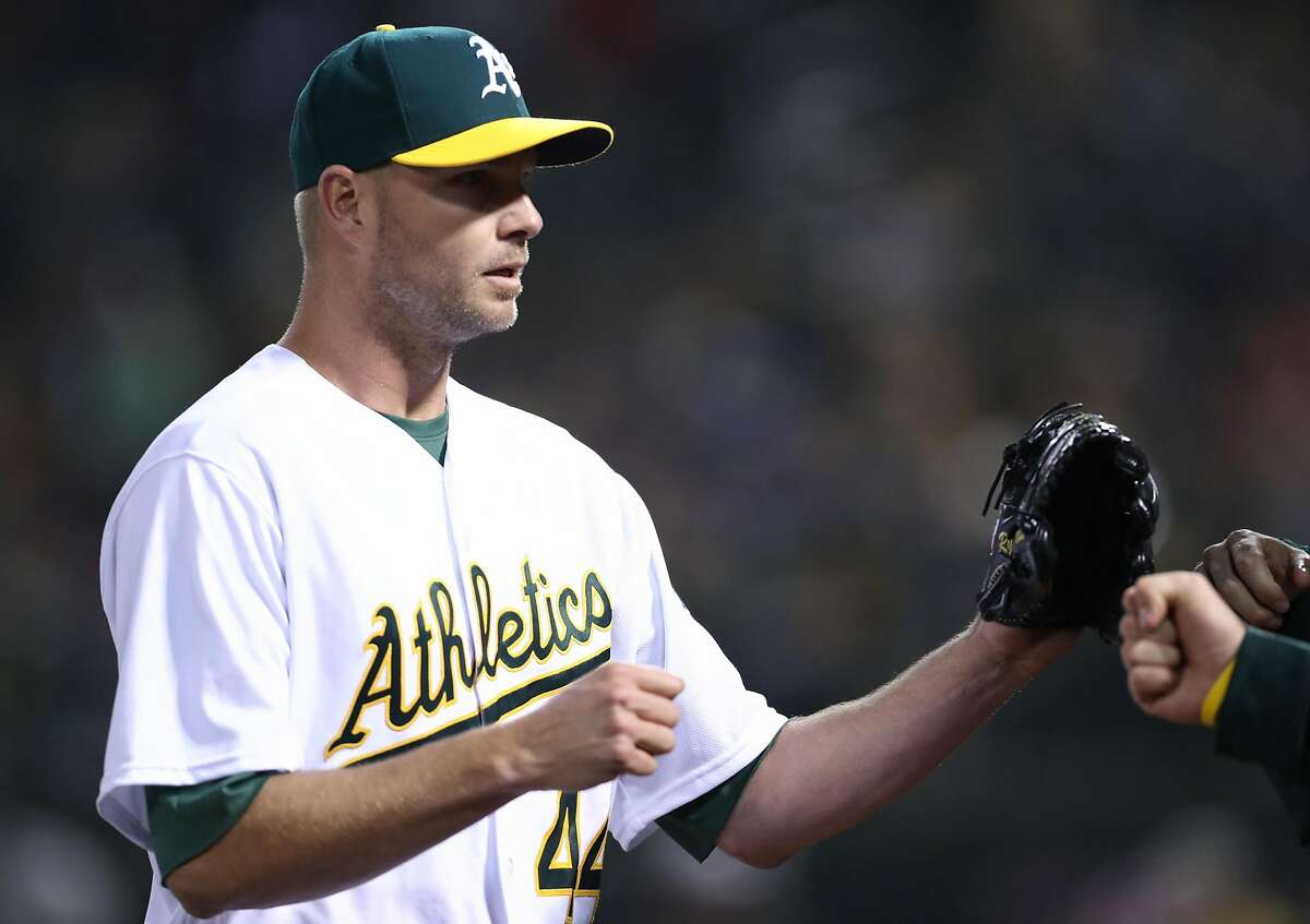 Oakland Athletics' Ryan Madson returns to dugout after getting third put of 8th inning during 4-2 win over Anaheim Angels during A's home opener at the Oakland Coliseum in Oakland, Calif., on Monday, April 3, 2017.