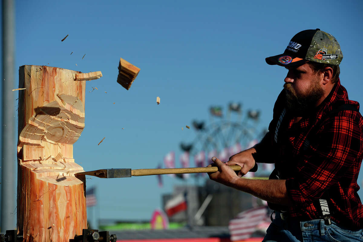 Lyle LeCaptain chops a log while standing on a springboard during the Paul Bunyan Lumberjack Show at the YMBL South Texas State Fair on Monday afternoon. Photo taken Monday 4/3/17 Ryan Pelham/The Enterprise