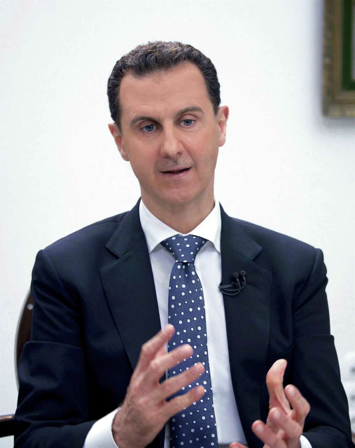 In this photo released by the Syrian official news agency SANA, Syrian President Bashar Assad, speaks during an interview with Hong-Kong based Phoenix TV in Damascus, Syria, Saturday, March 11, 2017. Assad said that his military's priority is to reach Islamic State de-facto capital Raqqa, where U.S.-backed Kurdish-led forces are advancing. (SANA via AP)