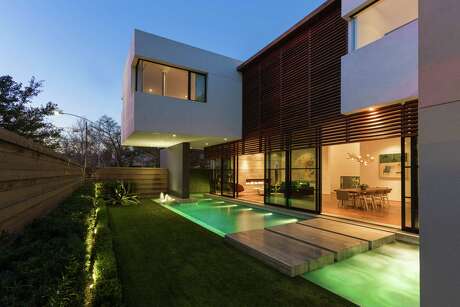 At night, the yard, pool and home of builder-developer Jonathan Farb lights up.