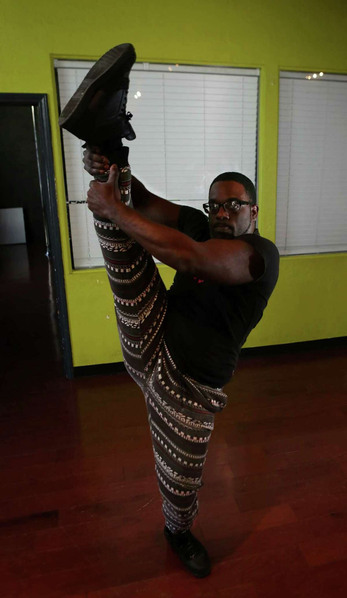 Before teaching a chair dancing class at Inner Me Dance Studio, Johnson demonstrates a leg grab.