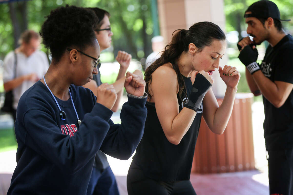 Title Boxing trainer Alexandra Casey, right, gives boxing pointers to computer information systems student Rhiana Jackson on Monday, April 3, 2017, at Lone Star College-Montgomery.