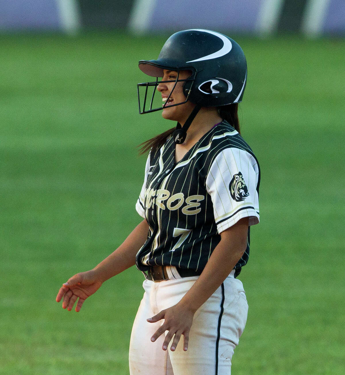Laryssa Gonzales #7 of Conroe smiles after hitting an RBI double to score Makenna Evans during the fourth inning of a District 12-6A high school softball game Tuesday, April 4, 2017, in Conroe. Oak Ridge defeated Conroe 4-2.