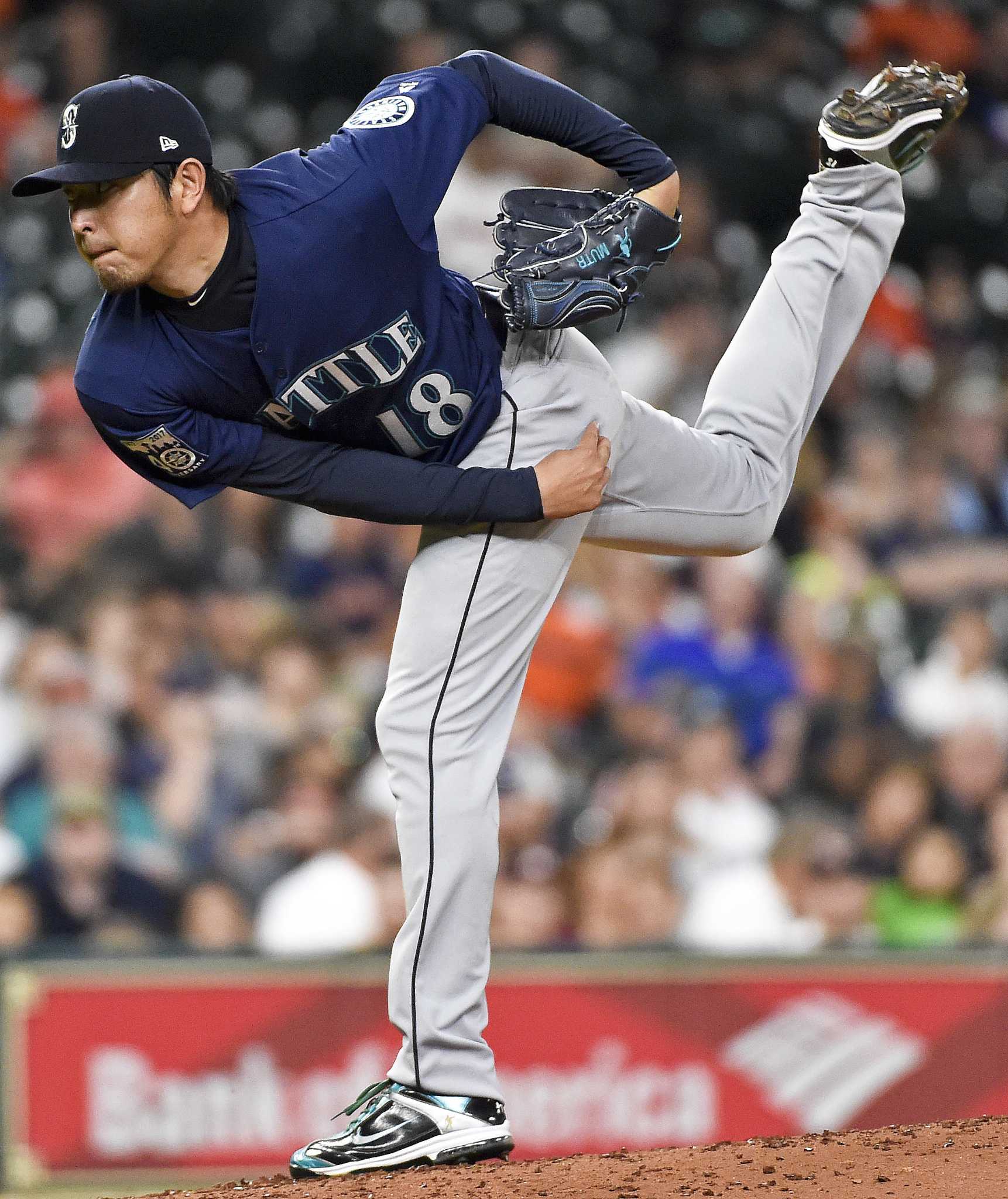 Baseball player Hisashi Iwakuma pitches