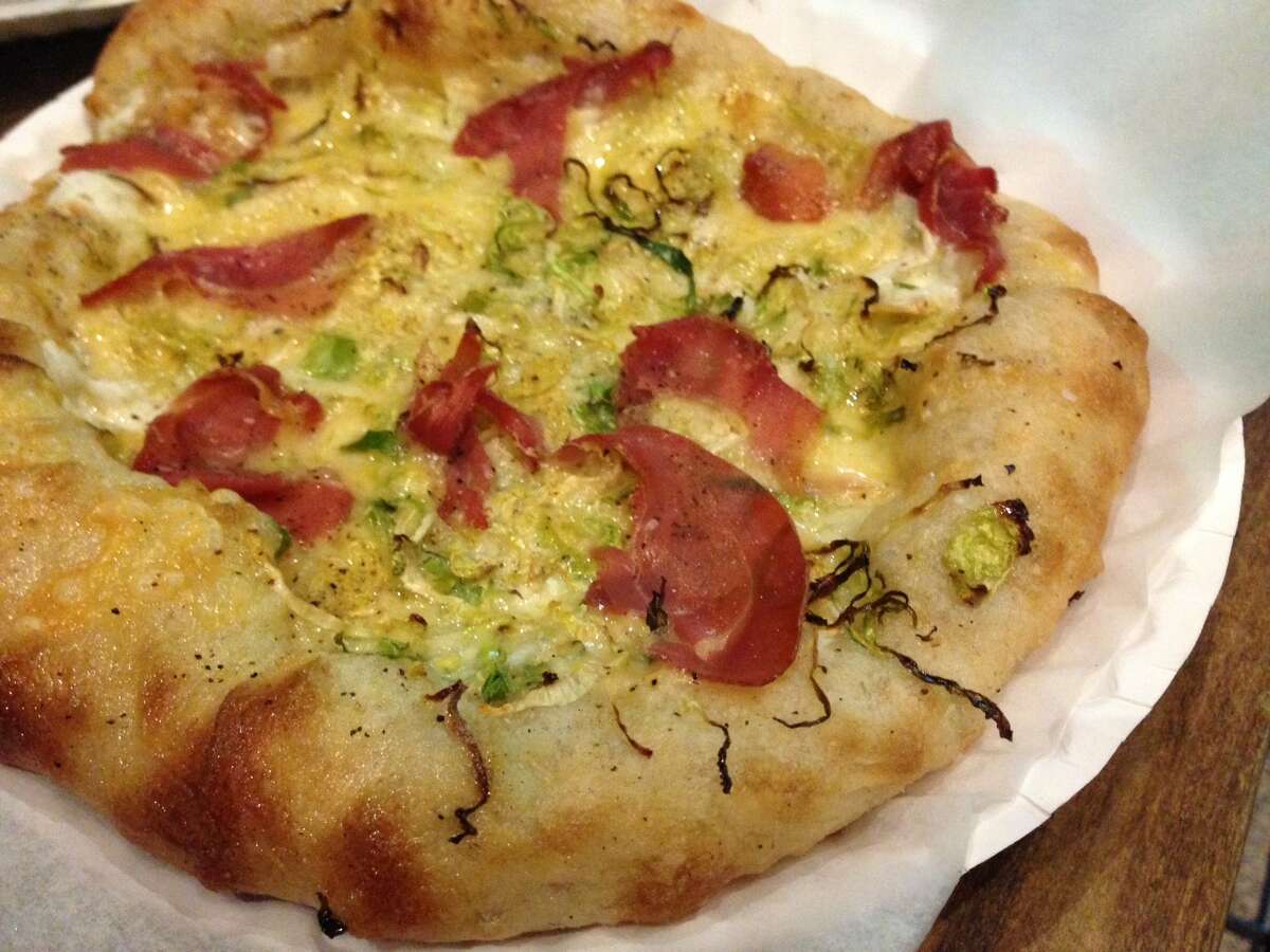 Prosciutto pizza with shaved Brussels sprouts, mozzarella and fontina from Arte Pizzeria, a new concept opening in the Conservatory food hall in downtown Houston.