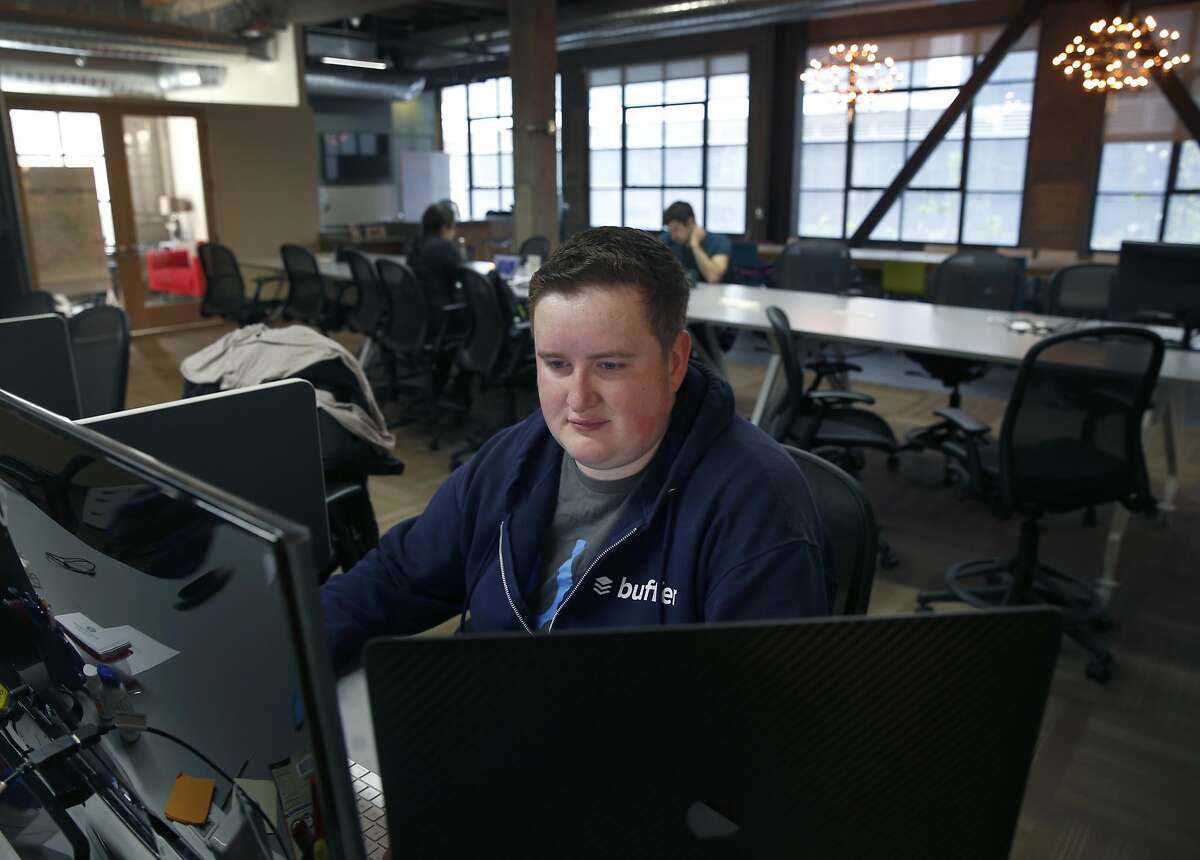 Andrew Yates logs into his job for Buffer at the Galvanize shared workspace on Howard Street in San Francisco, Calif. on Wednesday, April 5, 2017.