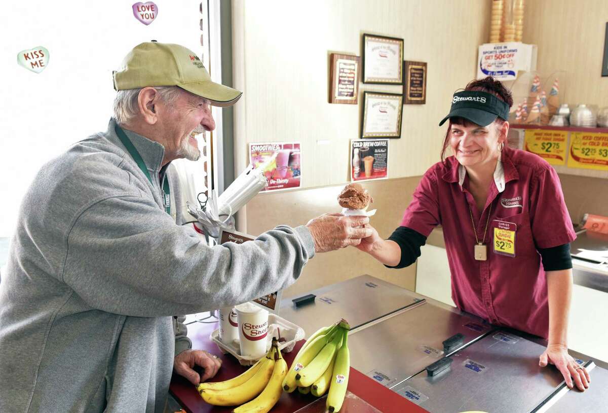 Frank Faragon, left, of Colonie gets a 50-cent single scoop ice cream cone from Stewarts Shops Everett Road manager Chriss Overholt Tuesday Feb. 14, 2017 in Colonie, NY. (John Carl D'Annibale / Times Union)