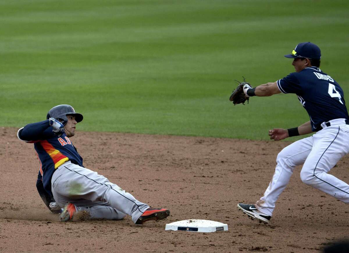 Houston Astros’ Leo Heras (left) slides safely to second base under pressure from San Diego Padres’ Luis Urias during the eighth inning of a spring training game in Mexico City on March 27, 2016.
