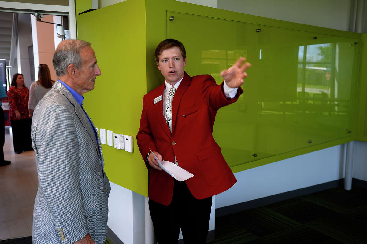 Dan Hallmark listens as mechanical engineering student Marcus Rodgers gives him a tour during a dedication ceremony for the new Center for Innovation, Commercialization and Entrepreneurship at Lamar University on Wednesday. The center aims to bring together science, engineering and business students to build business opportunities around their research. The second floor of the building also has office space and resources for new start-ups. Photo taken Wednesday 4/5/17 Ryan Pelham/The Enterprise