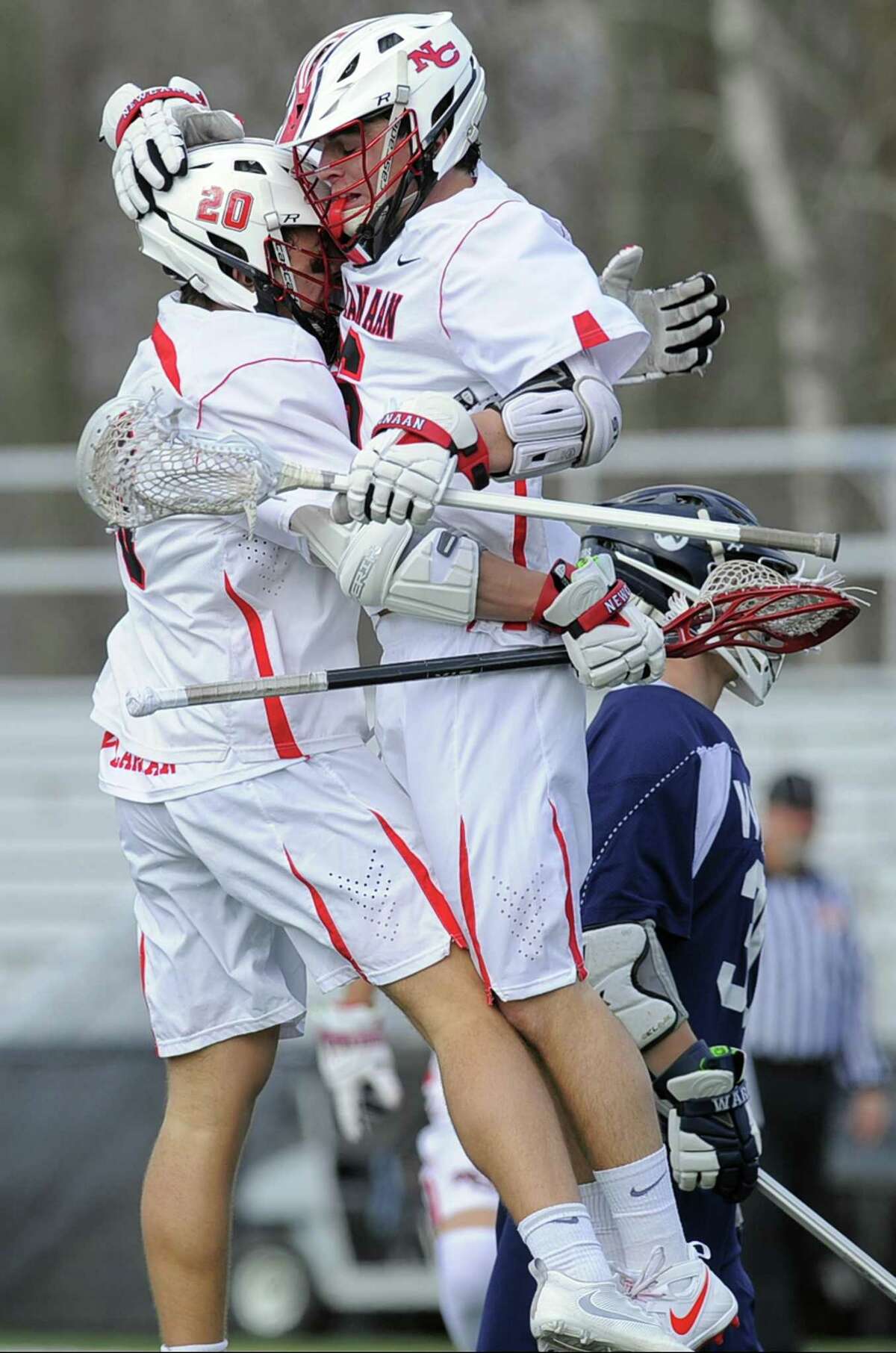 New Canaan Quintin O'Connell celebrates with his brother Ryan O'Connell after Ryan scored in the first half against Wilton of a boys lacrosse match at New Canaan High School Dunning Field on April 5, 2017. New Canaan defeated Wilton 9-8.