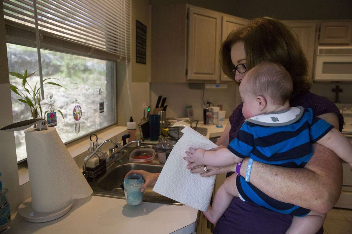 Kathy Friend, a therapeutic foster parent, prepares to feed an infant she is babysitting for another foster family at her home in San Antonio on March 24, 2017.