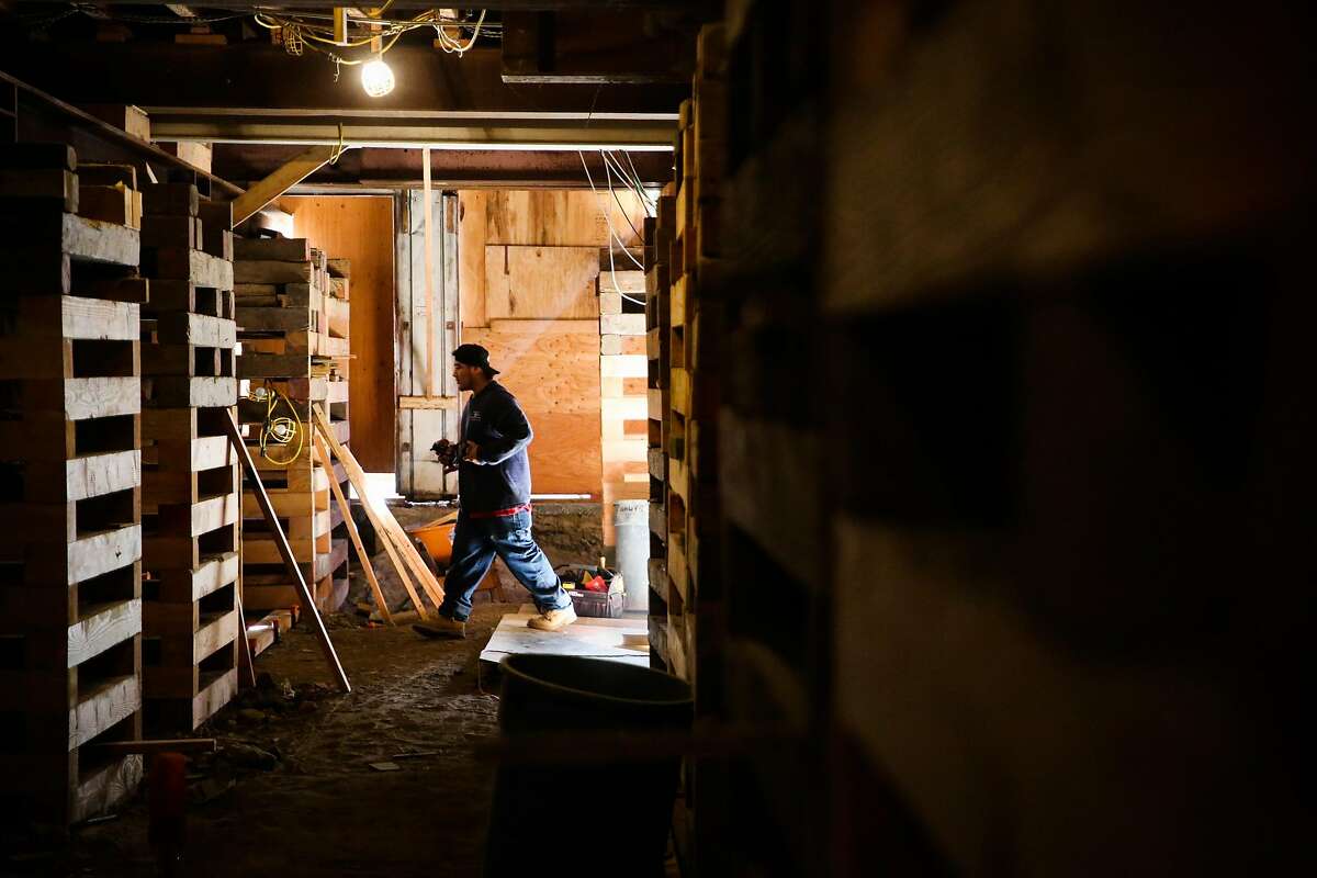 Rafael Bilchis, who works for Seismic Retrofitters, walks through the basement of a building while doing construction work in the Marina District in San Francisco, California, on Tuesday, March 28, 2017.