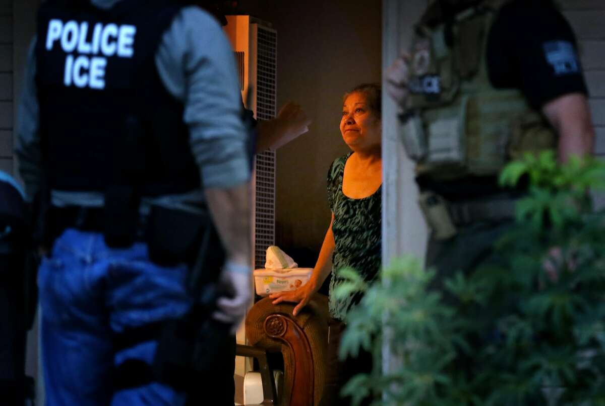 RIVERSIDE, CA - AUGUST 12: ICE Enforcement and Removal Operations officers, in search of 32-year-old Hugo Medina, question his mother Magdalena Medina, 69, about his whereabout in a morning raid on his residence in Riverside. 