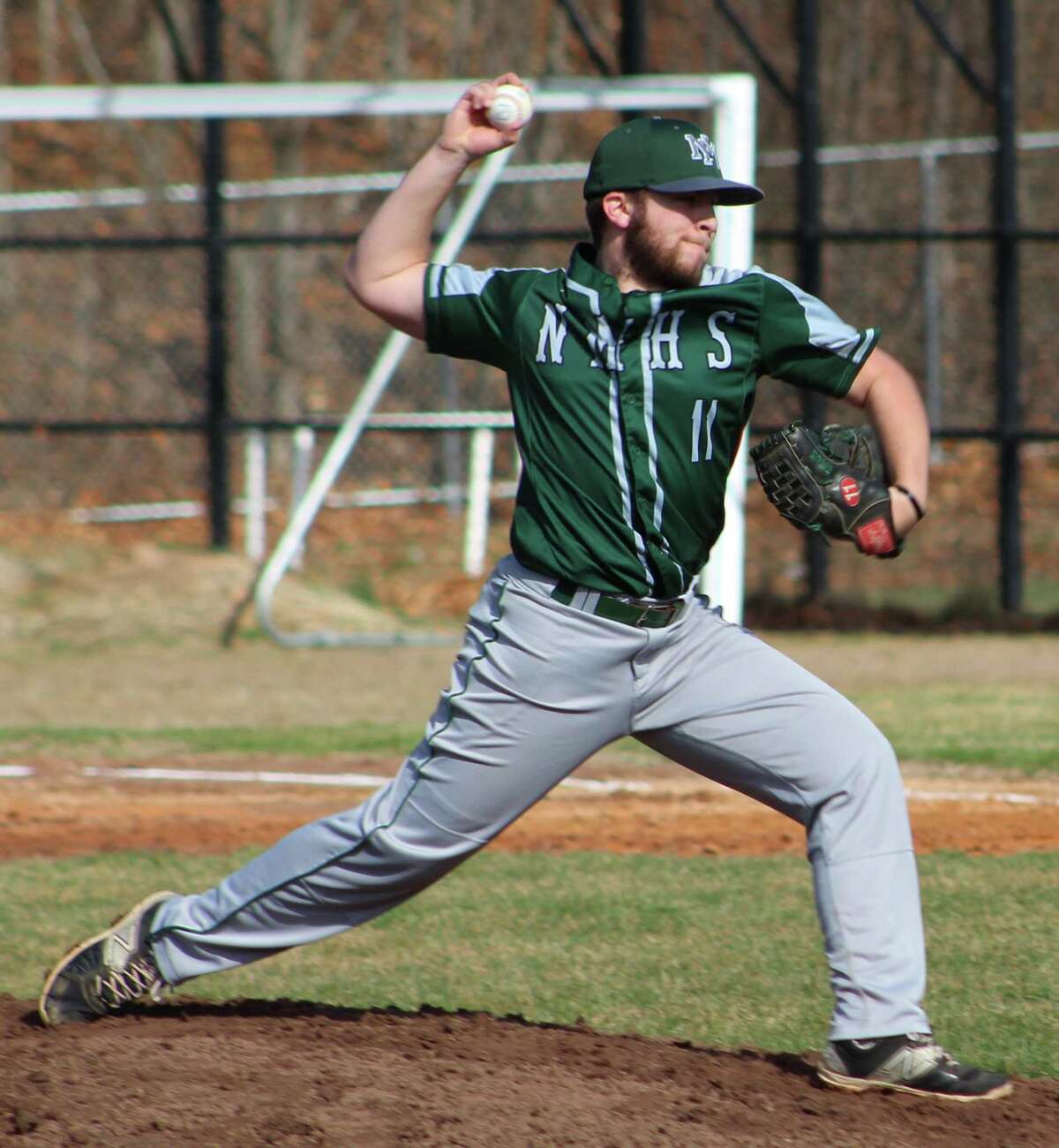New Milford's Gavin Titus fires a pitch during the baseball game at Abbott Tech in Danbury April 5, 2017.