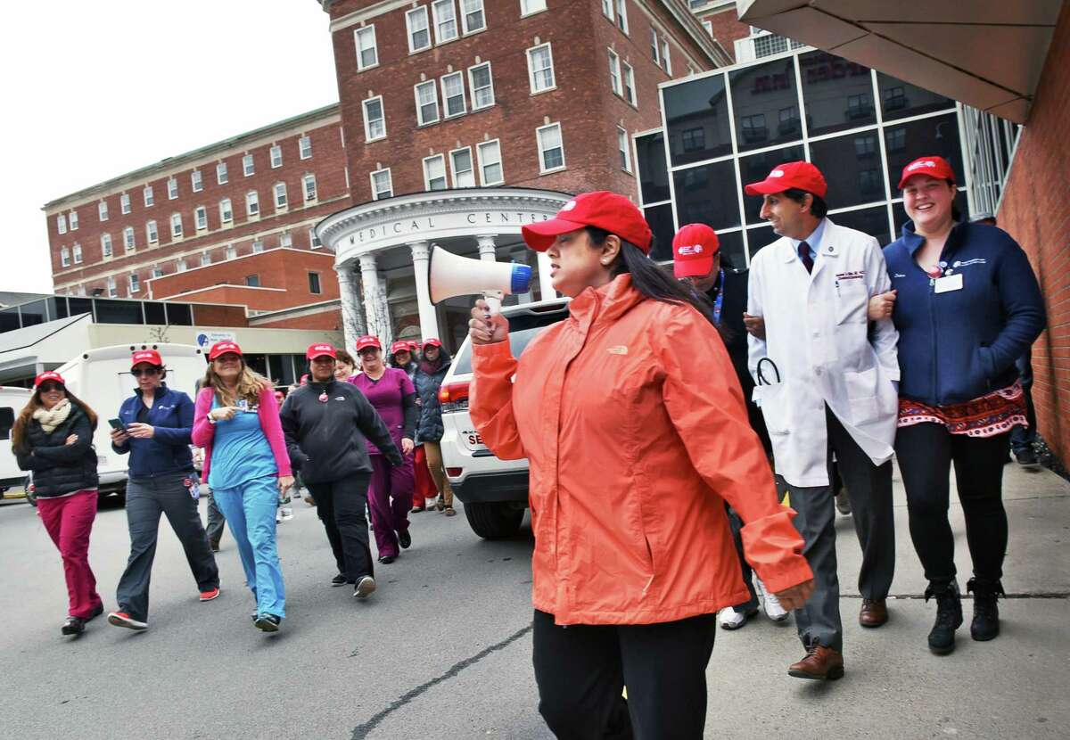 Cardiologist Dr. Suzie Mookherjee, center, leads Albany Medical Center staff as they partners with the American Heart Association for a walk through the Park South neighborhood for National Walking Day Wednesday April 5, 2017 in Albany, NY. (John Carl D'Annibale / Times Union)