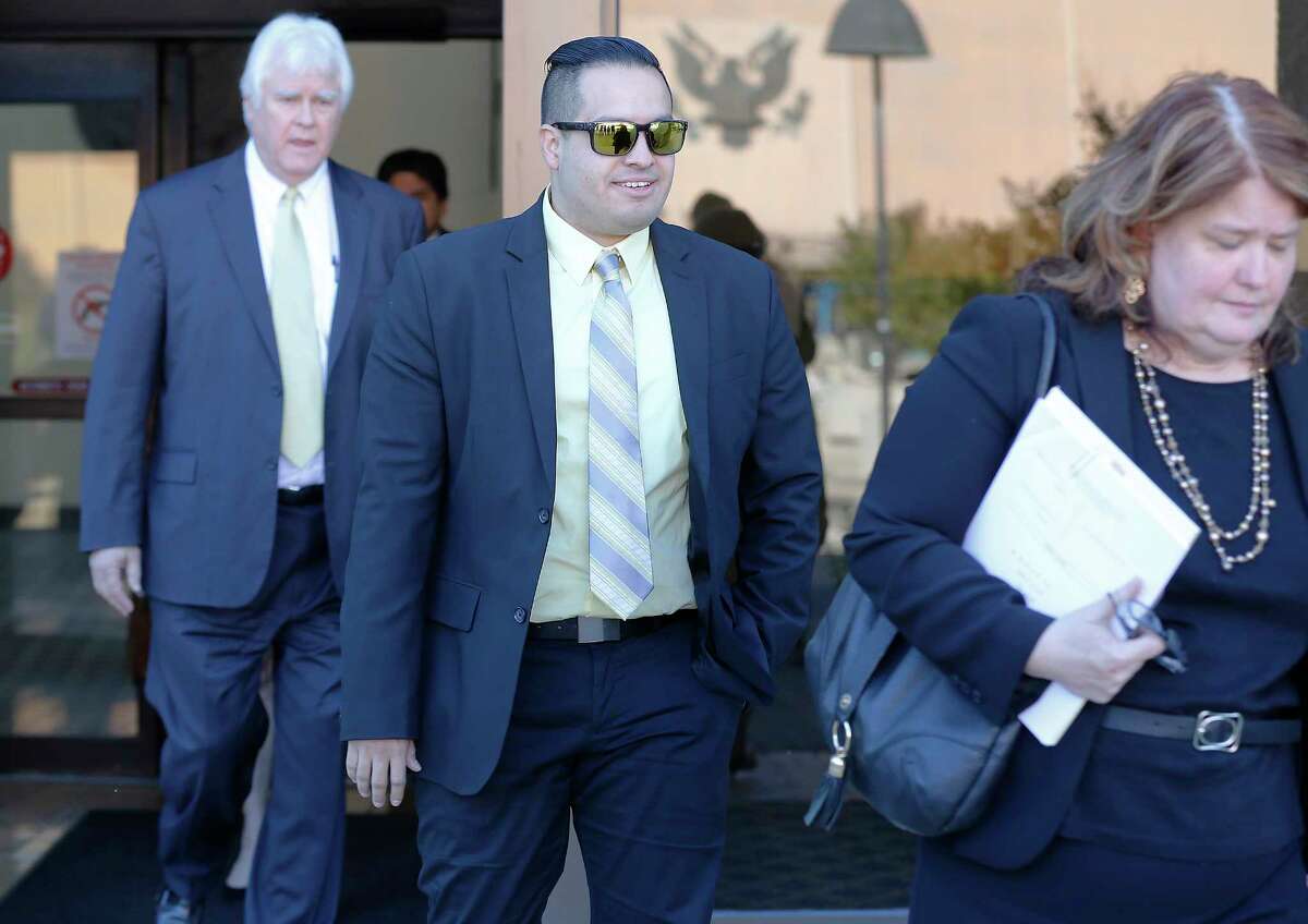 San Antonio Police Officer Robert Encina leaves the John Wood Federal Courthouse on Thursday, Apr. 6, 2017 after a federal jury found him not guilty in a civil case for the February 2014 shooting of Marquise Jones. Walking beside Encina was City Assistant Attorney Debbie Klein.