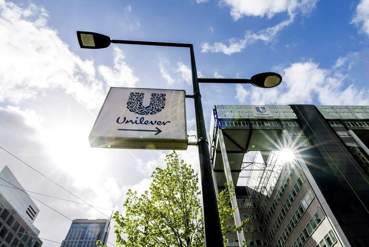 Under pressure after spurning a blockbuster $143 billion takeover offer, Unilever says it will explore the sale of its spreads business, restructure two major divisions and buy back $5.3 billion in stock as it seeks to cut costs and appease investors.