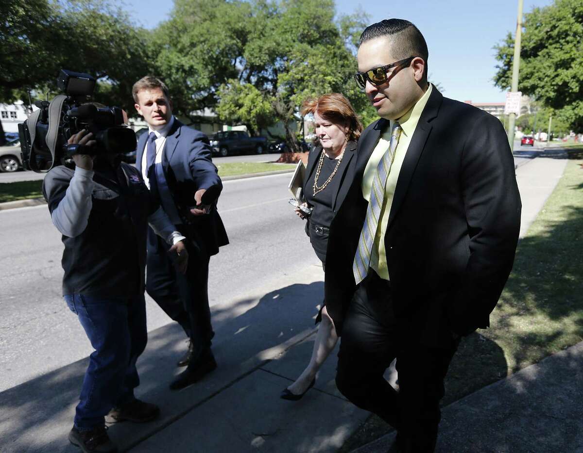 San Antonio Police Officer Robert Encina leaves the John Wood Federal Courthouse on Thursday, Apr. 6, 2017 after a federal jury found Encina and the city were not liable for the February 2014 shooting of Marquise Jones. Walking beside Encina was City Assistant Attorney Debbie Klein. (Kin Man Hui/San Antonio Express-News)