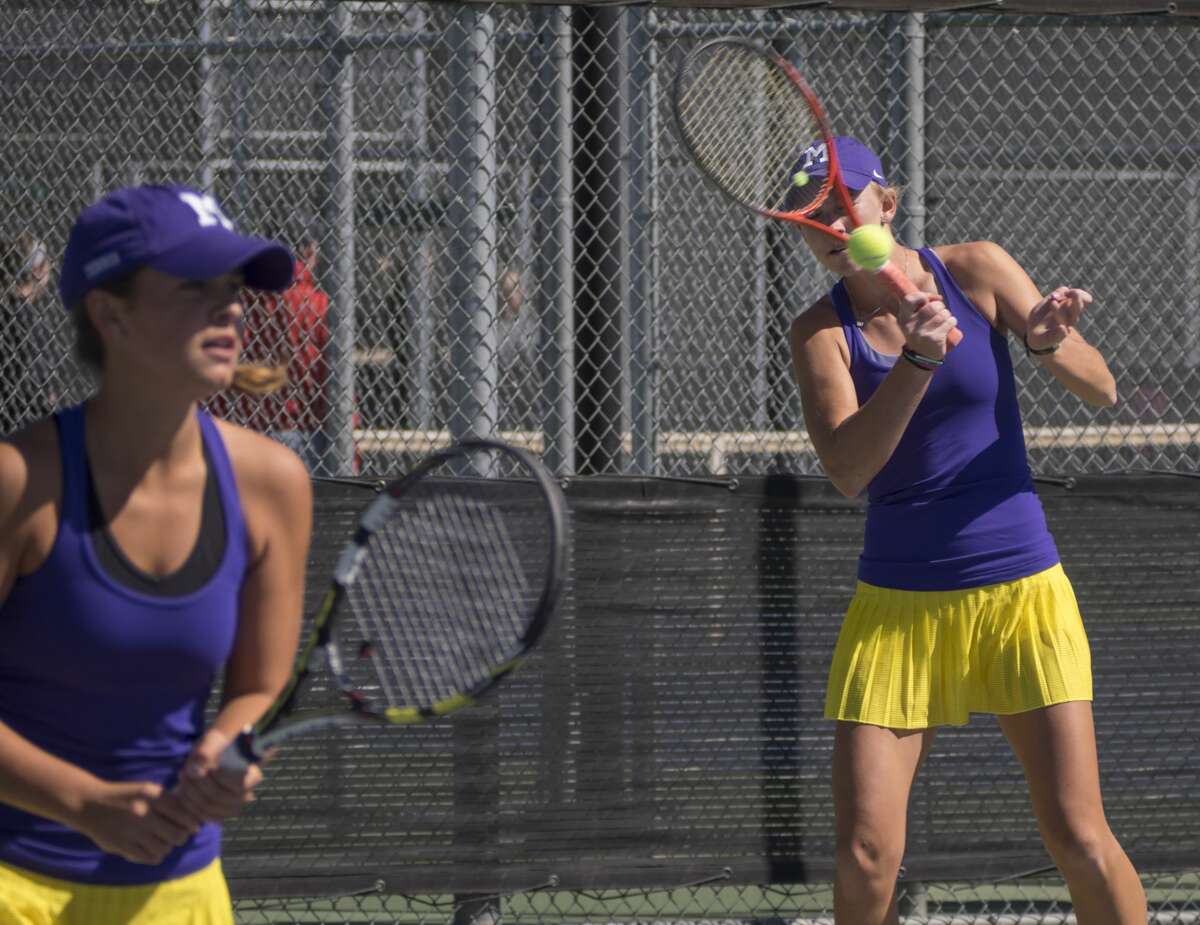 Midland High's Kate Daugherty returns a shot with doubles partner Allison Stewart 04-06-17 during the first day of District 2-6A tournament action. Tim Fischer/Reporter-Telegram