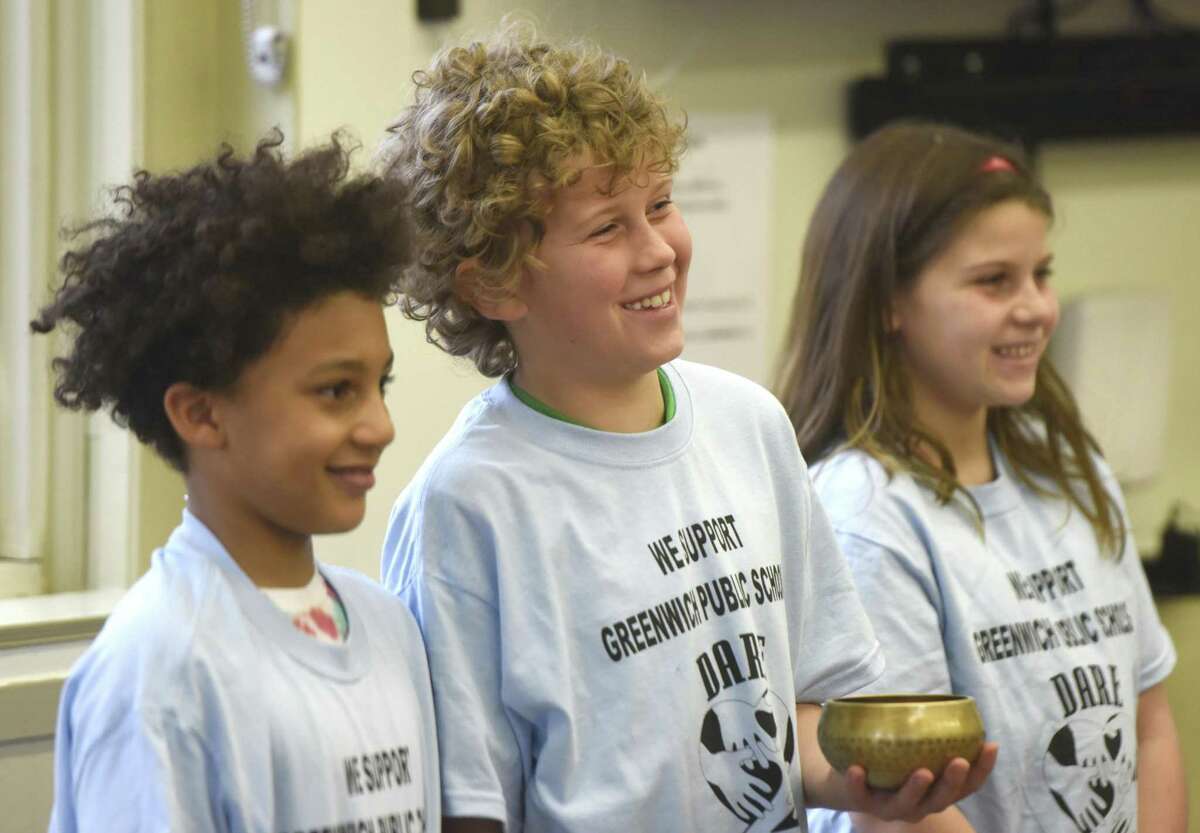 Julian Curtiss fifth-graders, Jaden Scott, left, Logan Jozwiak and Lauren Resnick give a mindfulness presentation to Greenwich first responders at the Board of Education in Greenwich, Conn. Thursday, April 6, 2017. Representatives from the Greenwich police, fire and EMS services learned about mindfulness and stress-management strategies that can be helpful in their day-to-day work.