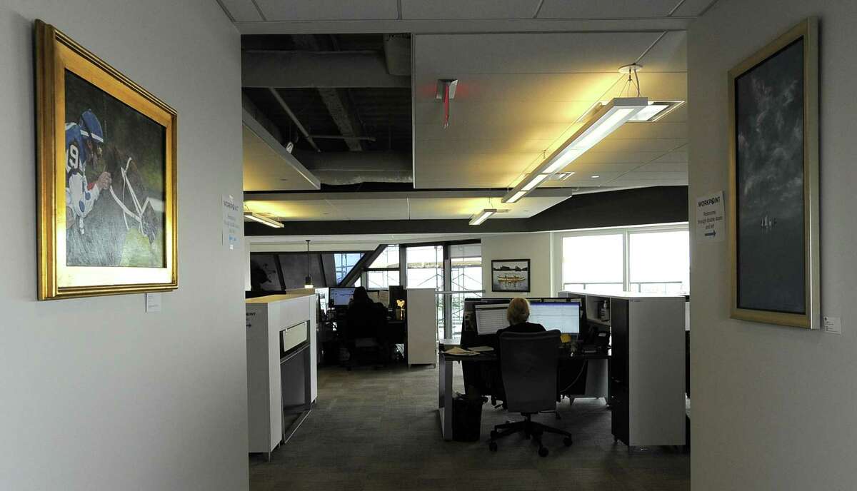 An employee of an international financial company based in Munich, Germany uses a cubical space at Workpoint Center in Stamford, Connecticut. Workpoint is the planned site of a financial-technology presentation series that is scheduled to start later this year.