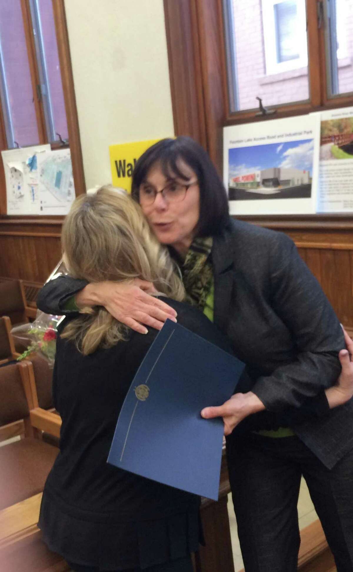 Ansonia Superintendent of Schools Carol Merlone hugs Kim Martin, a 20-year school employee, for her actions in saving a choking student