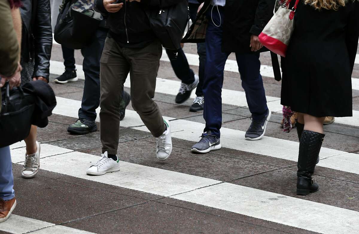 Office workers cross Battery and Market streets as they walk to their jobs in the Financial District in San Francisco, Calif. on Thursday, April 6, 2017. Thursday was recognized as Walk to Work Day.