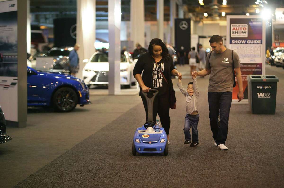 Aaron and Evony Castaneda swing their son Ian, 3, as they walk through the Houston Auto Show at NRG Center, Thursday, April 6, 2017, in Houston. The family has made it a yearly tradition to attend the auto show together, and they made a point to come on Thursday when the show was less busy. Ian said he was on the lookout for a Camaro, his favorite car.