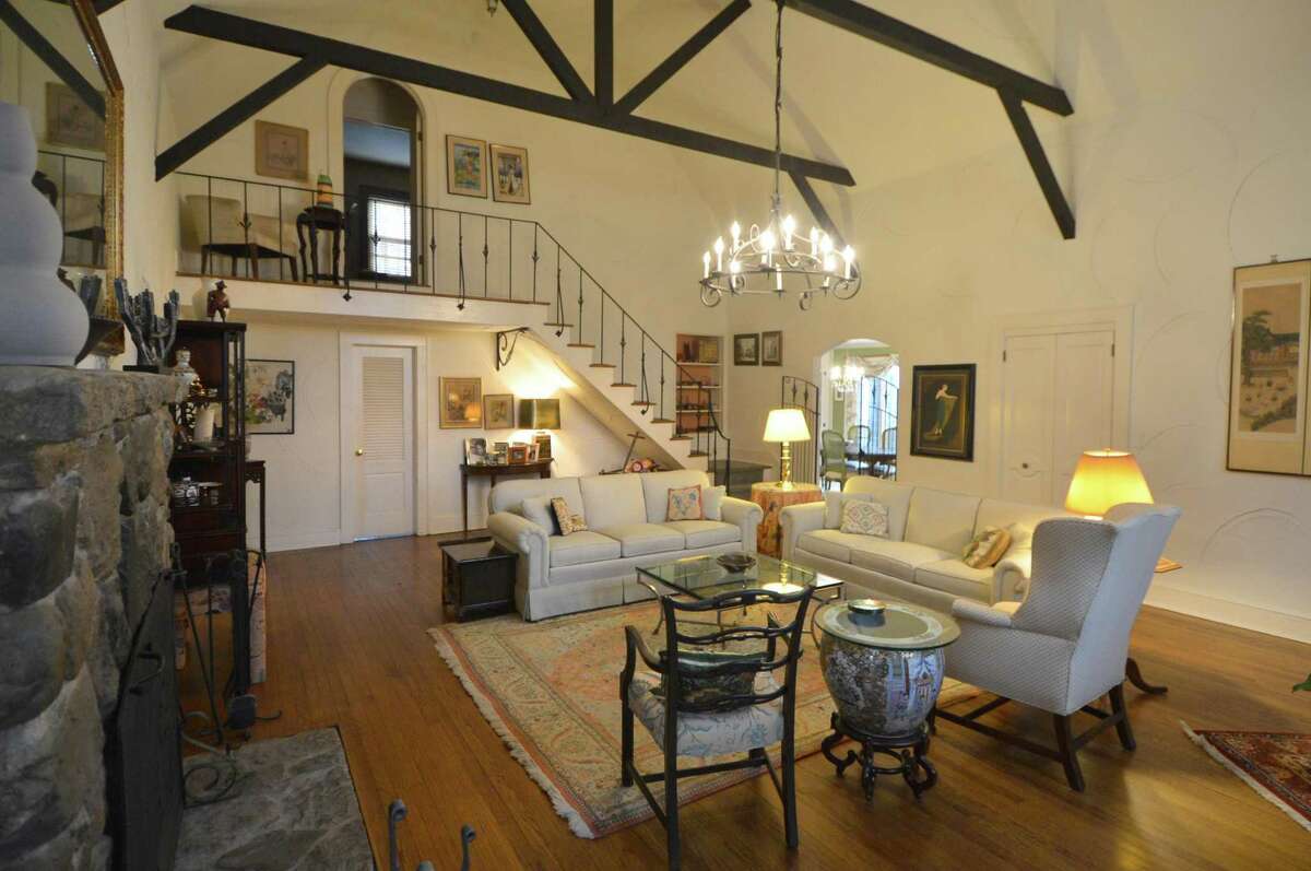The interior of the property known as Cosywood featuring exposed beams, vaulted ceiling and ornate wrought iron.